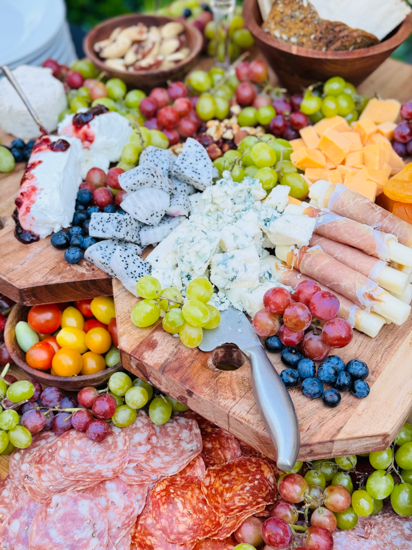 Abundant grazing board with cheeses, fruit, and cured meats
