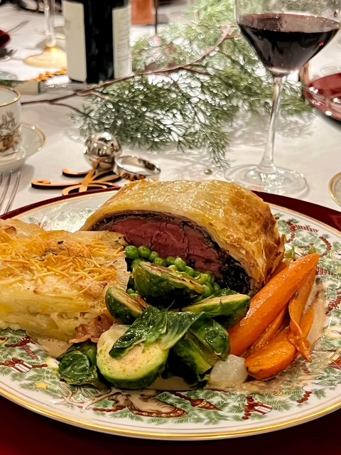 Plated beef Wellington with potato gratin and vegetables