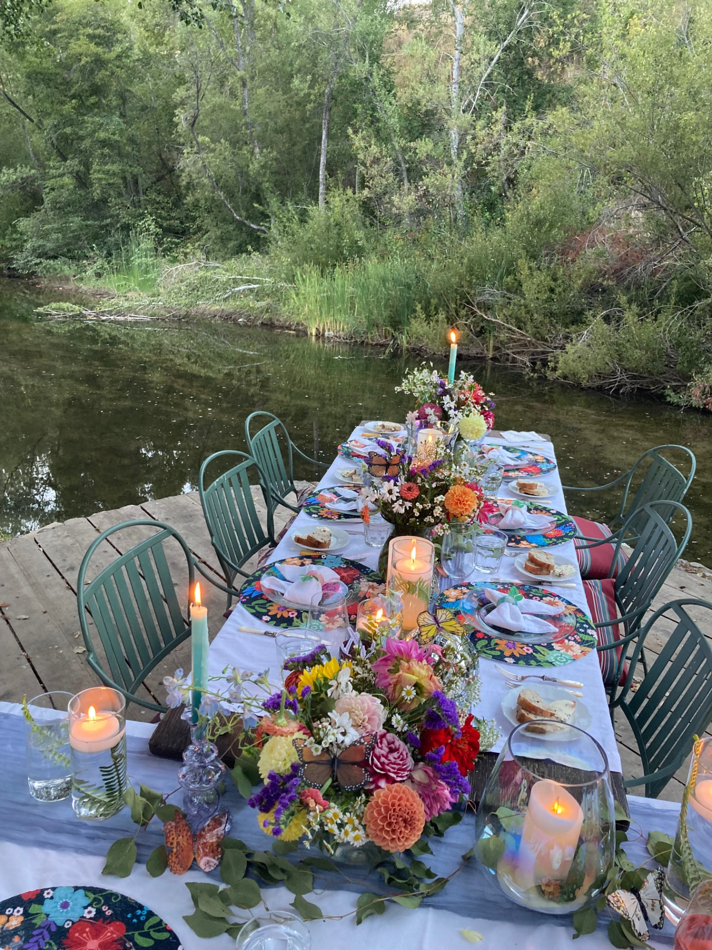 Long riverside table set with florals and candlelight