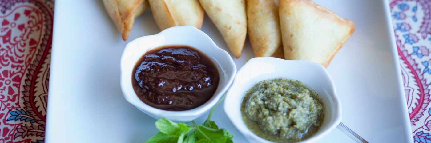 Samosas with tamarind and mint chutneys