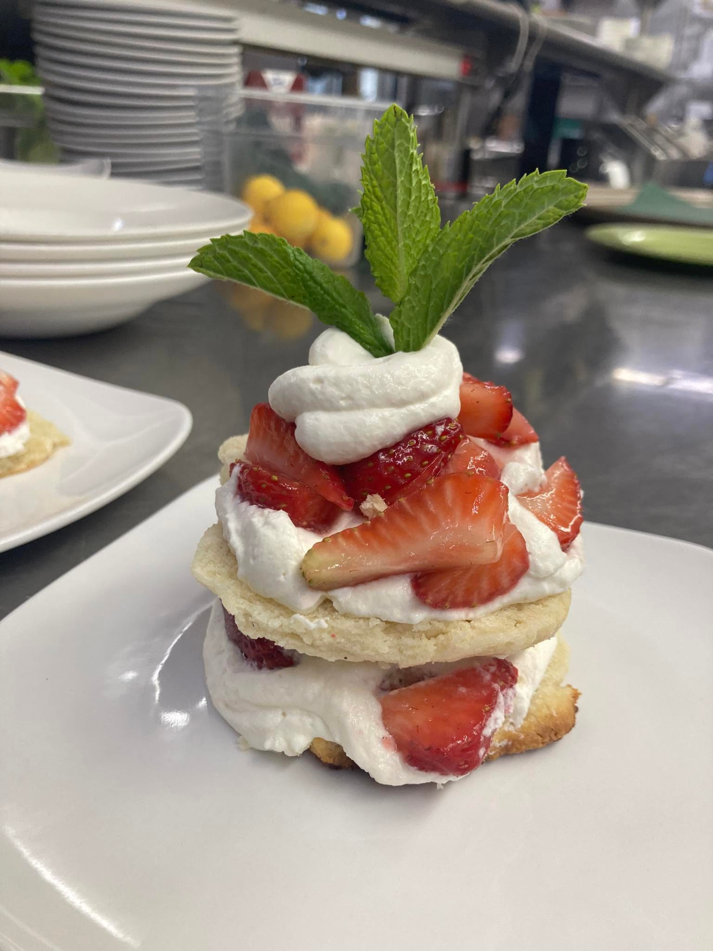 Strawberry shortcake with whipped cream and mint